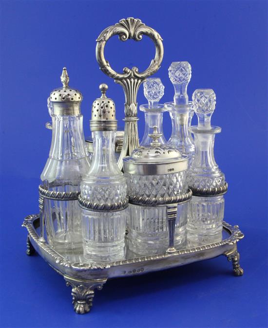 A George III silver cruet stand with eight cut glass bottles, overall height 9.5in.